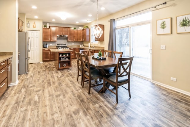 dining room featuring sink and hardwood / wood-style flooring