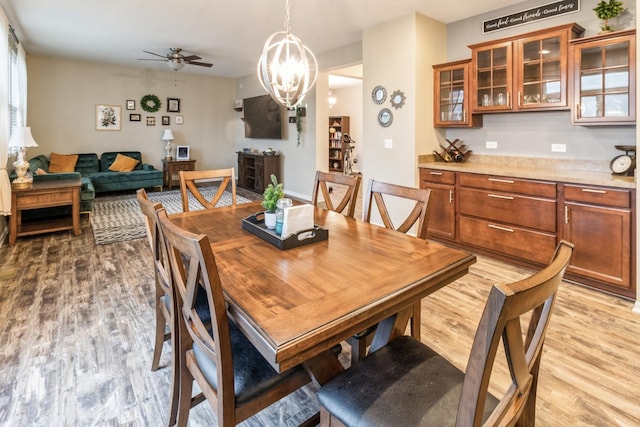 dining space featuring ceiling fan and light wood-type flooring