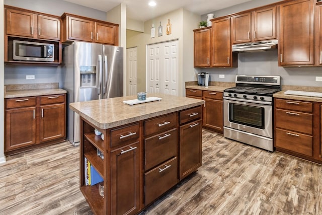 kitchen featuring stainless steel appliances, a center island, and light hardwood / wood-style floors