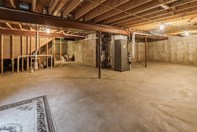 basement featuring gas water heater and heating unit