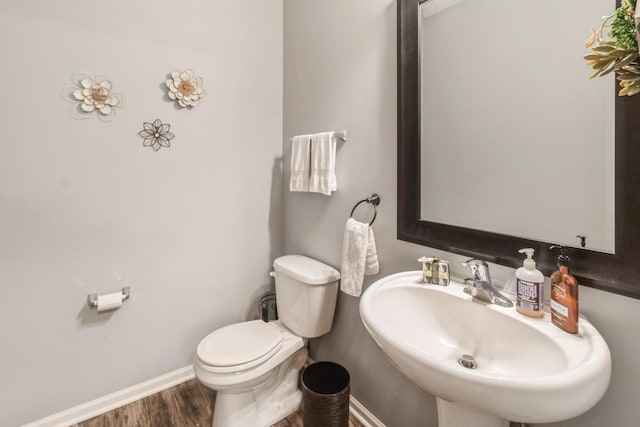 bathroom featuring sink, hardwood / wood-style flooring, and toilet