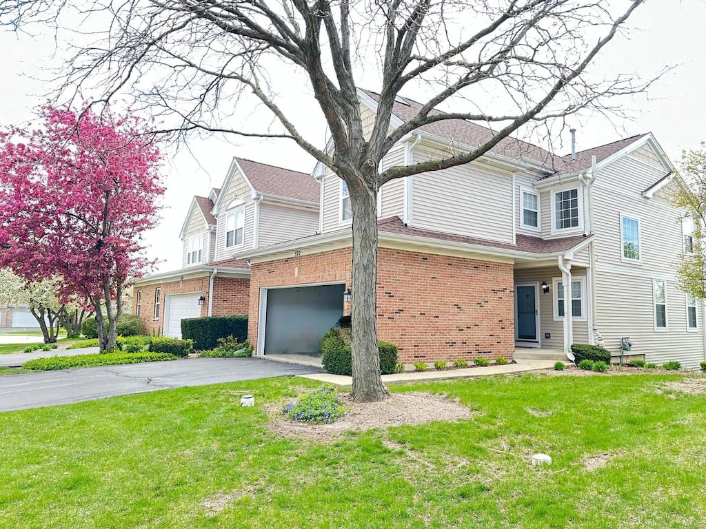 view of front of property featuring a garage and a front yard