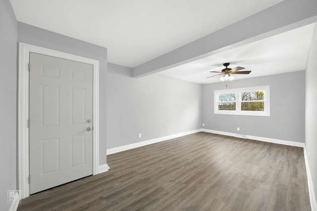 unfurnished room with ceiling fan, dark wood-type flooring, and beam ceiling