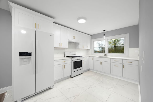 kitchen featuring white cabinetry, sink, white appliances, and pendant lighting