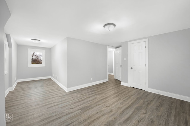 unfurnished room featuring dark hardwood / wood-style flooring