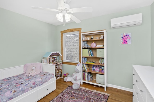 bedroom featuring a wall mounted air conditioner, ceiling fan, and light hardwood / wood-style flooring