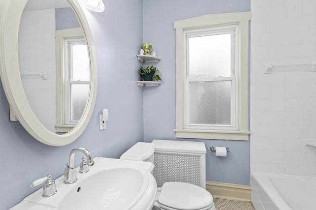 full bathroom with sink, tile patterned floors, toilet, and shower / washtub combination