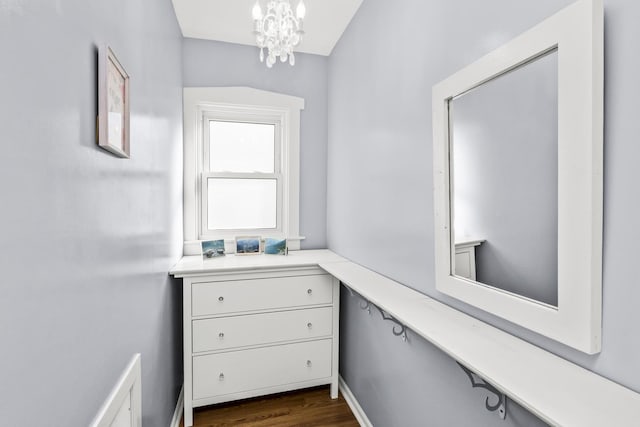 bathroom featuring hardwood / wood-style flooring and a chandelier