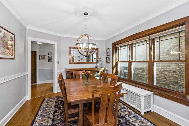 dining room with crown molding, radiator, a notable chandelier, and dark hardwood / wood-style flooring