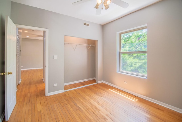 unfurnished bedroom with ceiling fan, light hardwood / wood-style floors, and a closet