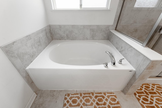 bathroom featuring tile patterned flooring and a bathing tub