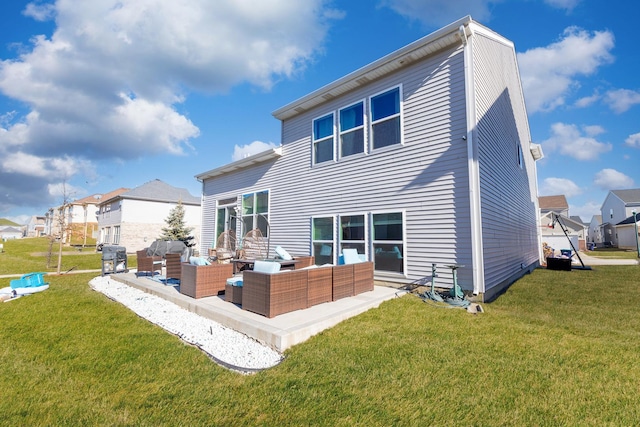 rear view of house with a patio, outdoor lounge area, and a yard