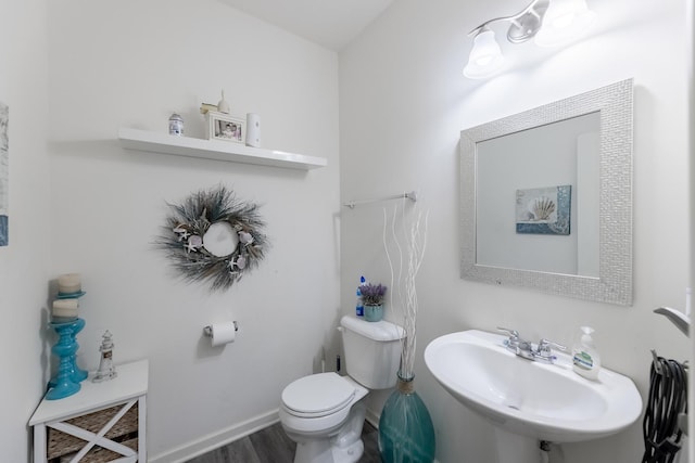 bathroom featuring hardwood / wood-style flooring, sink, and toilet