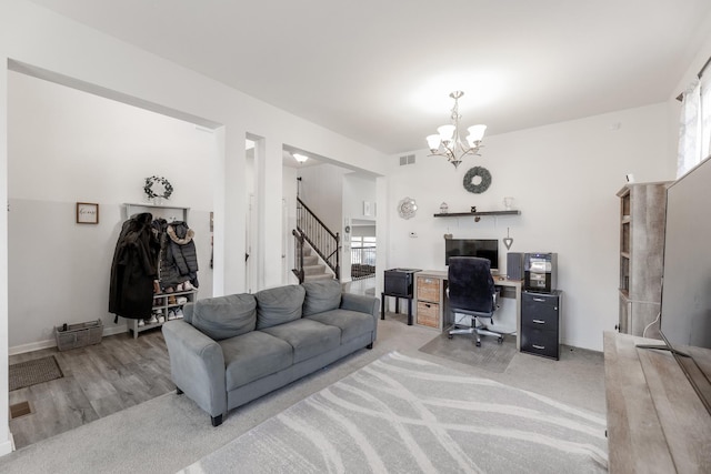 home office with an inviting chandelier and light carpet