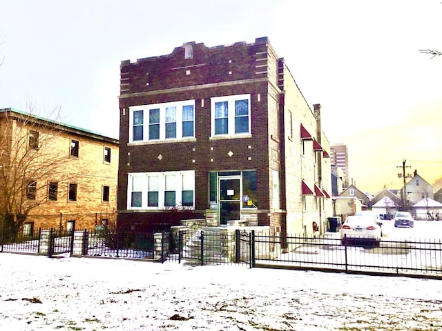 view of snow covered back of property