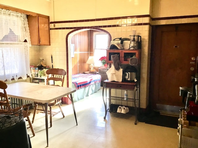 dining space with tile walls