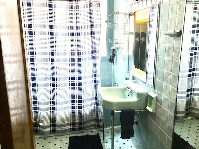 bathroom featuring tile walls and curtained shower