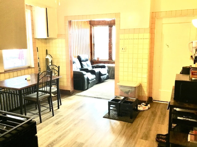 sitting room featuring light hardwood / wood-style flooring and tile walls