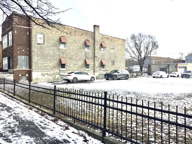 view of snow covered parking area