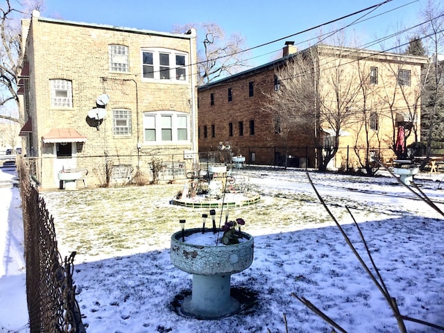 view of snow covered rear of property