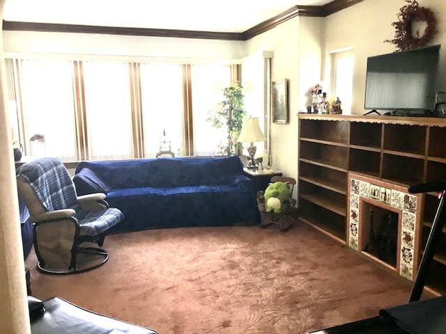 carpeted living room featuring ornamental molding, a tiled fireplace, and a wealth of natural light