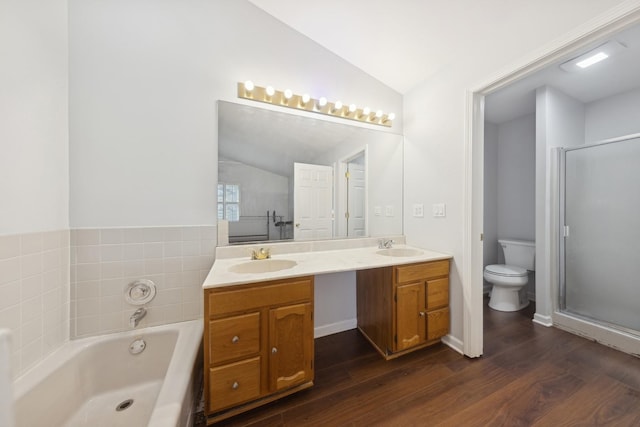 full bathroom with hardwood / wood-style flooring, vanity, toilet, and vaulted ceiling