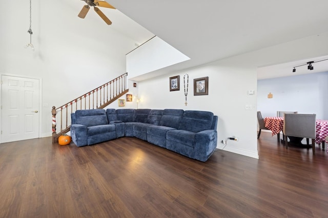 living room featuring dark hardwood / wood-style floors and ceiling fan