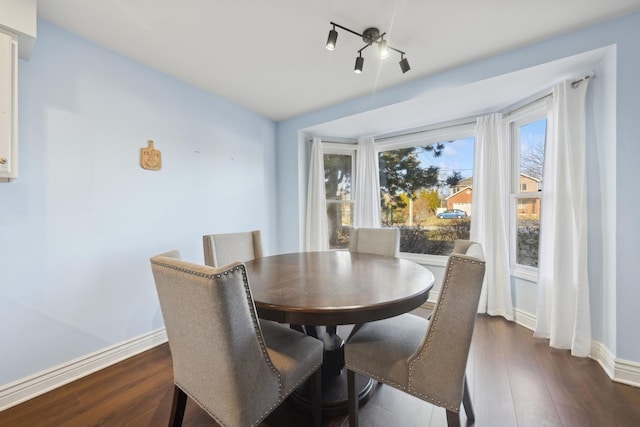 dining space with dark wood-type flooring