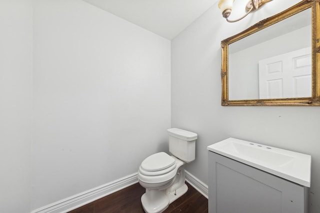 bathroom featuring vanity, hardwood / wood-style flooring, and toilet