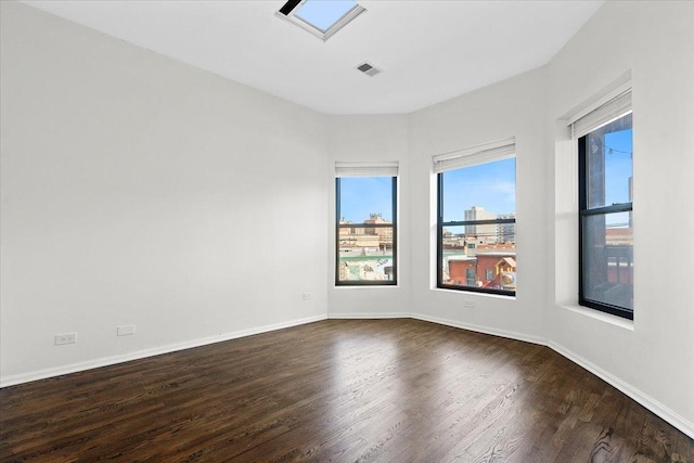 spare room featuring dark wood-type flooring