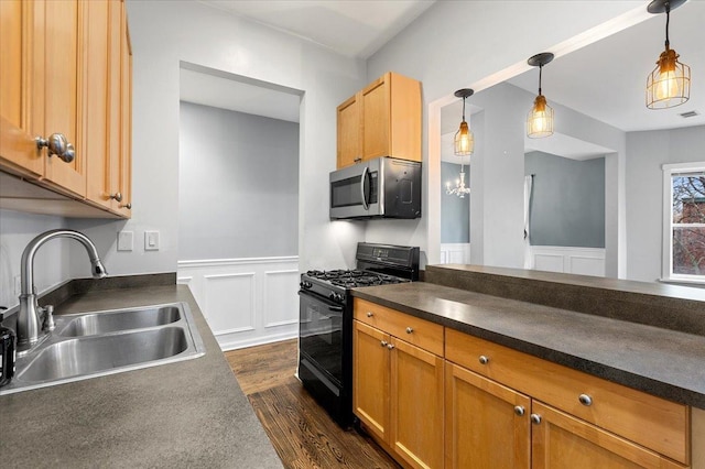 kitchen with black range with gas stovetop, dark hardwood / wood-style flooring, sink, and hanging light fixtures