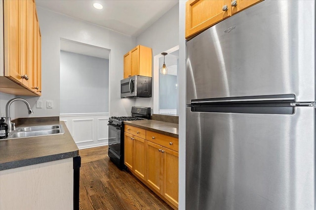 kitchen with decorative light fixtures, sink, stainless steel appliances, dark wood-type flooring, and light brown cabinets