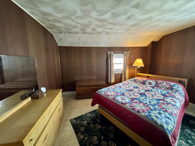 bedroom with wood walls