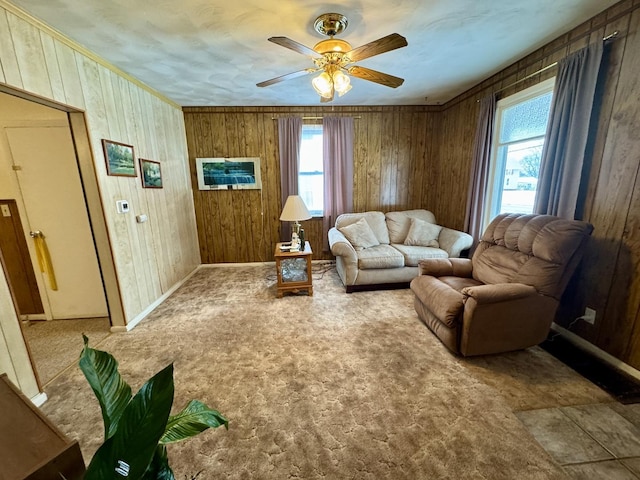 living room with carpet floors, a healthy amount of sunlight, and wood walls