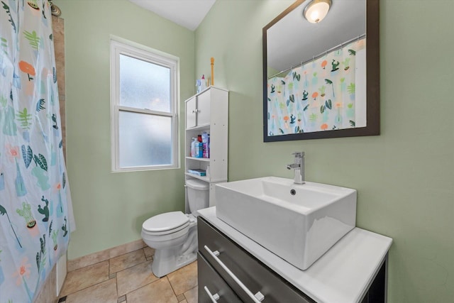 bathroom with vanity, tile patterned floors, toilet, and walk in shower