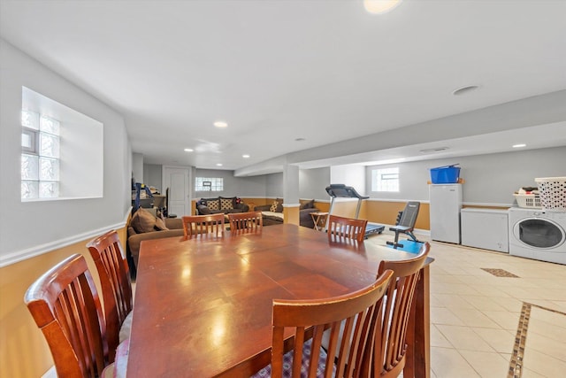 tiled dining room featuring washer / dryer