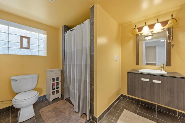 bathroom featuring tile patterned flooring, toilet, vanity, and a shower with shower curtain