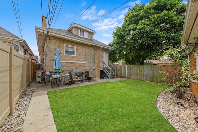 back of house with a lawn and a patio area