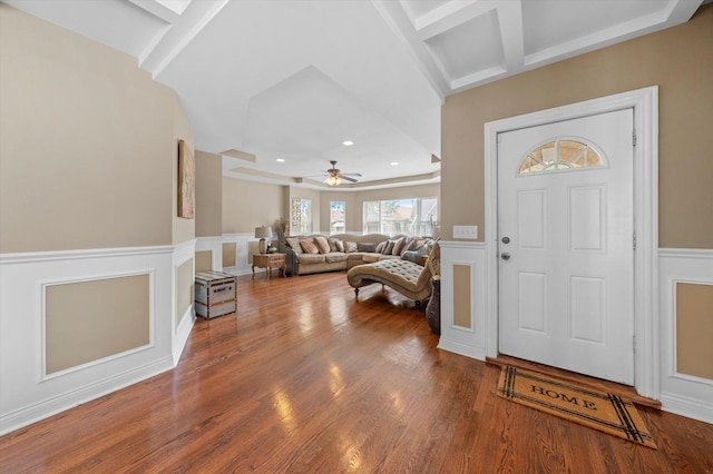 foyer entrance with ceiling fan, wood-type flooring, coffered ceiling, and beam ceiling