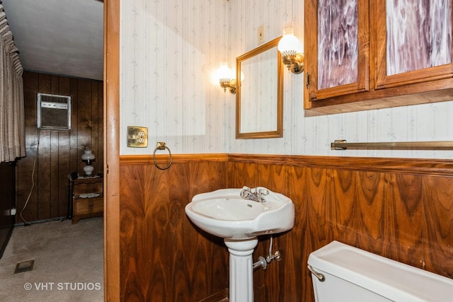 bathroom with a wall mounted air conditioner, toilet, and wood walls