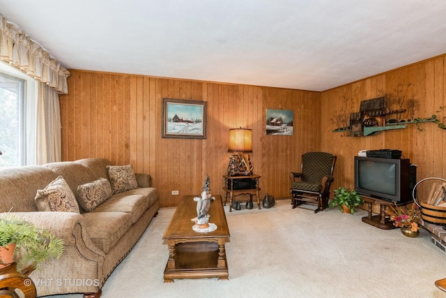 living room featuring wooden walls and carpet flooring