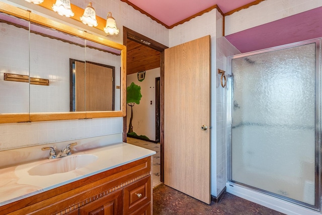 bathroom featuring a shower with door and vanity