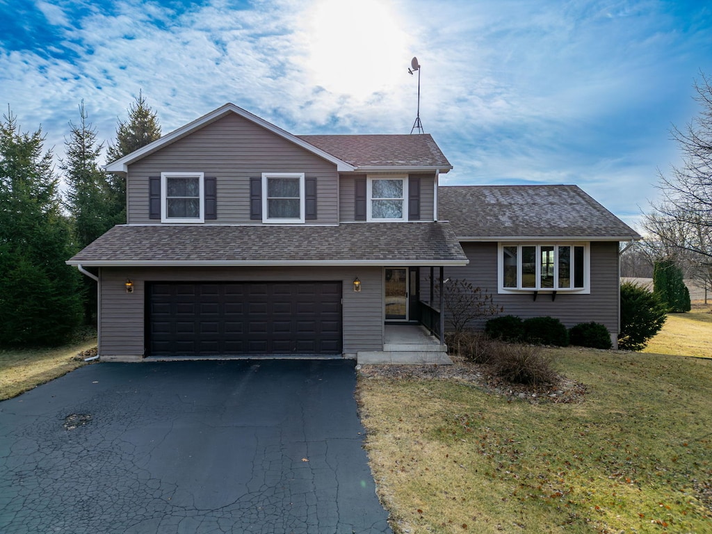 view of front of home featuring a garage and a front yard