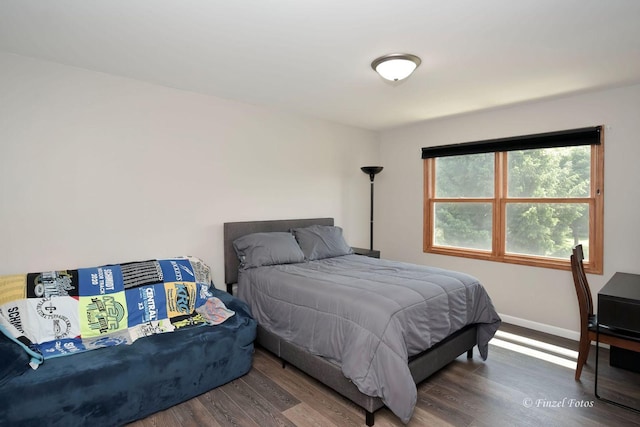 bedroom with dark hardwood / wood-style floors