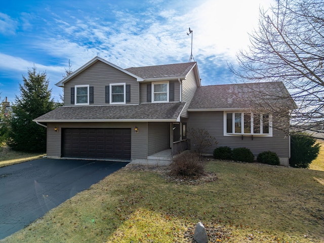 front of property with a garage and a front lawn