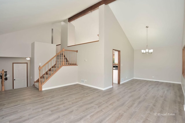 unfurnished living room featuring beamed ceiling, high vaulted ceiling, light wood-type flooring, and an inviting chandelier