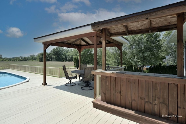 wooden deck with a gazebo and exterior bar