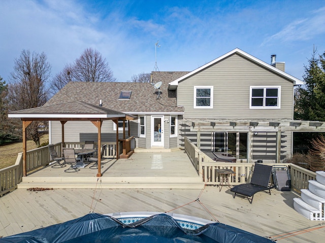 rear view of house featuring a pergola, a gazebo, and a deck