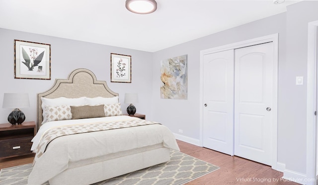 bedroom featuring hardwood / wood-style floors and a closet