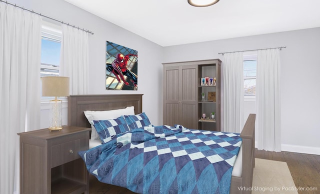 bedroom with dark hardwood / wood-style flooring